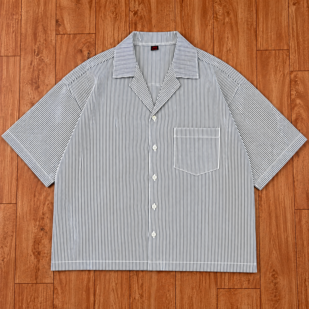 Men's white striped boxy fit shirt front view with button-up design