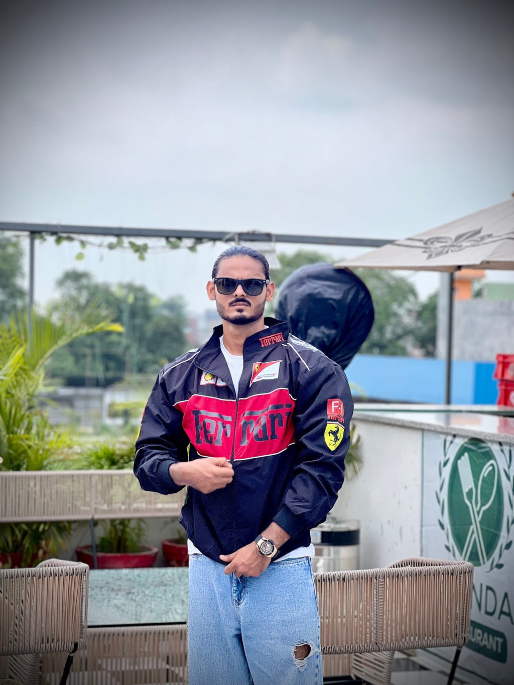 Indian male model wearing black Ferrari F1 printed jacket – XOVRA streetwear front view