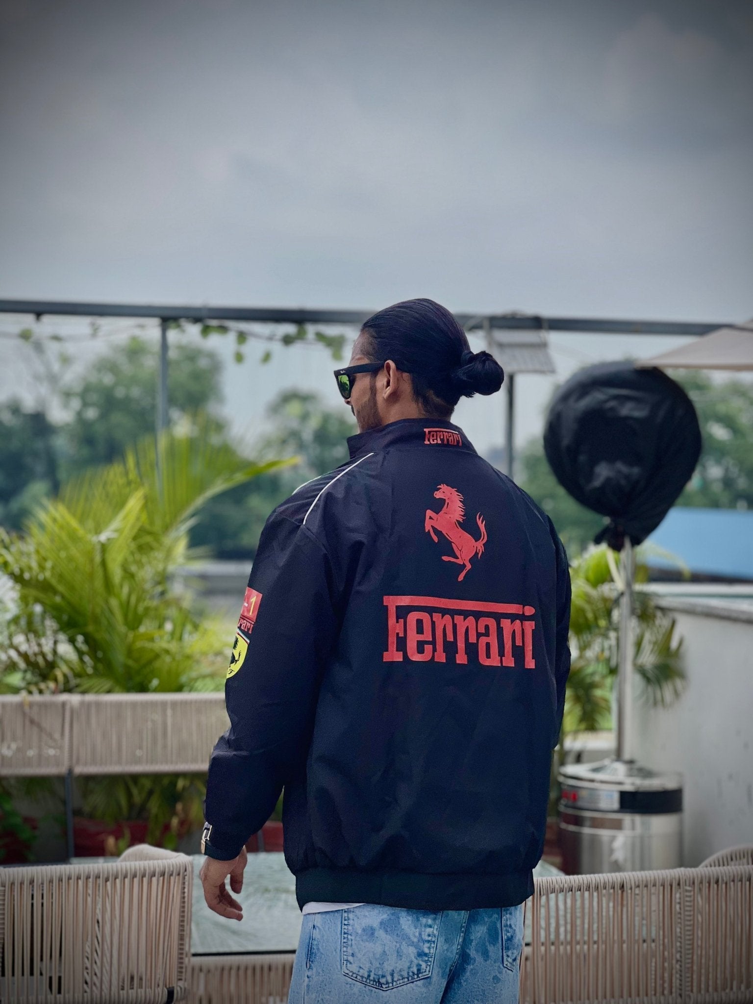 Full-body outfit of Indian male model wearing black Ferrari racing jacket – XOVRA India