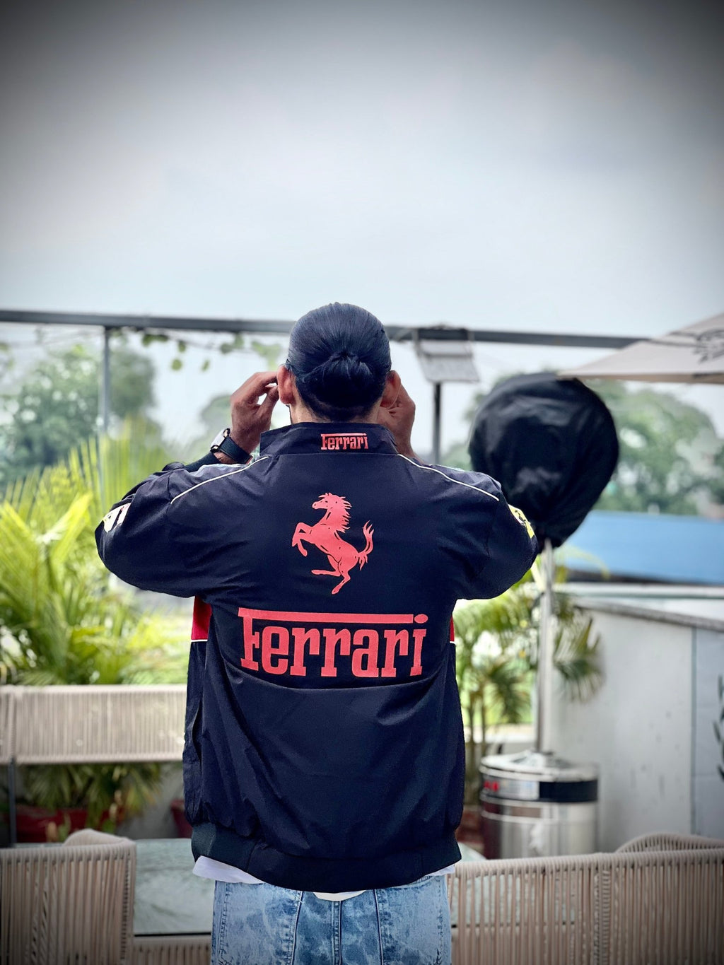 Close-up shot of black Ferrari printed jacket on Indian male model – XOVRA fashion